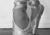 A ballerina's pointed feet are shown in a black and white image.