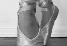 A ballerina's pointed feet are shown in a black and white image.