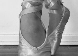 A ballerina's pointed feet are shown in a black and white image.