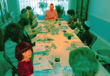 The author looks up from the table while her grandfather leads his last seder before his death in 2017.